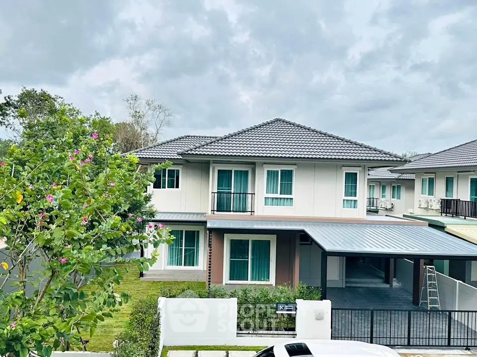 Modern two-story house with a spacious garden and carport in a serene neighborhood.