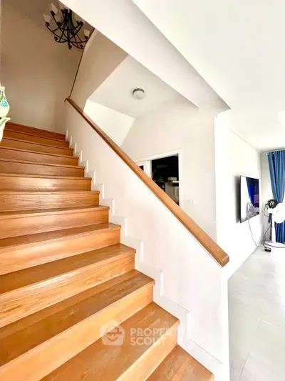 Bright and spacious interior with wooden staircase and modern living area