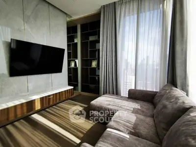Luxurious living room with modern decor, large TV, and plush sofa, perfect for relaxation.