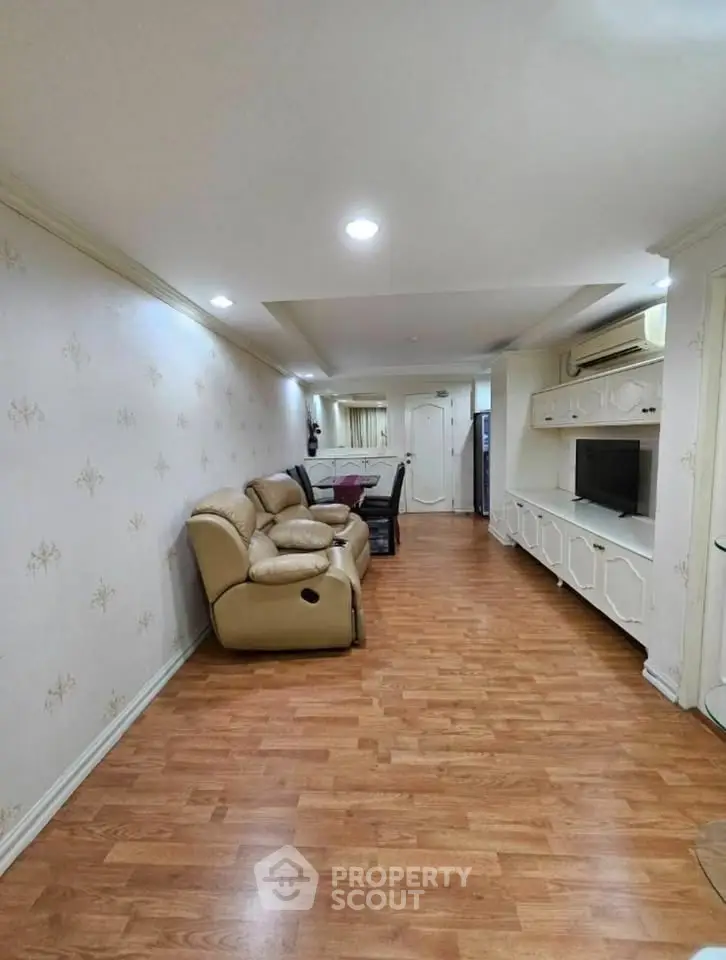 Spacious living room with elegant decor and comfortable seating in a modern apartment.
