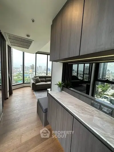 Luxurious modern living room with panoramic city view and elegant wooden flooring.