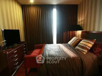 Cozy bedroom with modern decor and ambient lighting, featuring a comfortable bed and stylish furnishings.