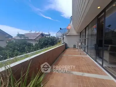 Spacious balcony with city view and satellite dishes, perfect for relaxation.