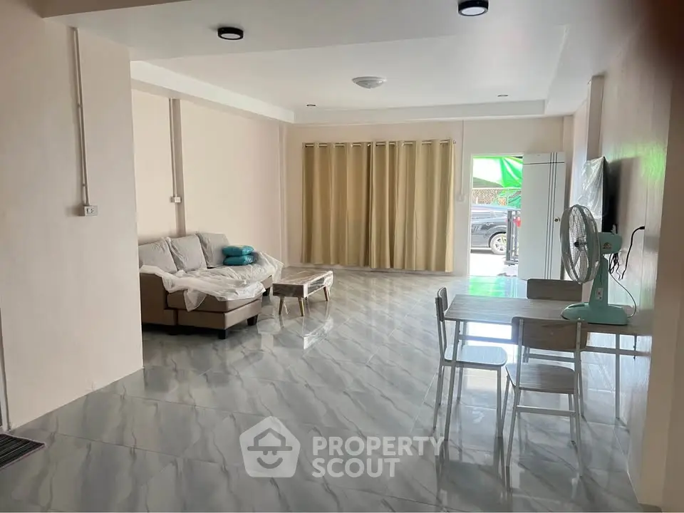 Spacious living room with modern furnishings and large windows for natural light.