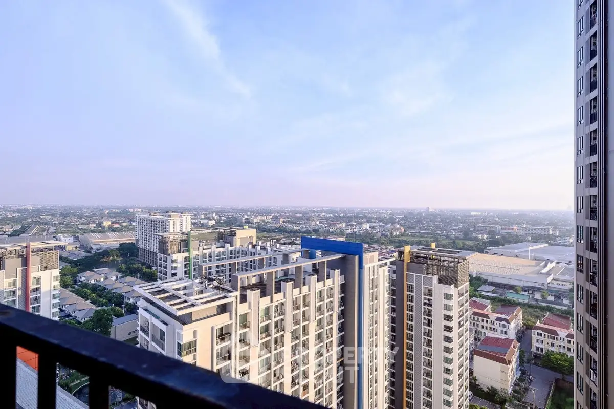 Stunning cityscape view from high-rise balcony showcasing urban skyline and horizon.