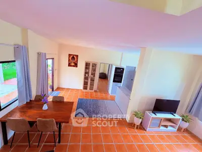Spacious open-plan living room with terracotta tiles and modern decor