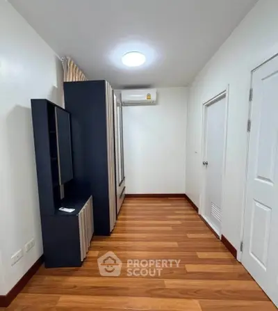 Modern storage room with sleek cabinetry and wooden flooring, perfect for organized living.