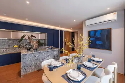 Luxurious dining area with elegant table setting and modern kitchen design.