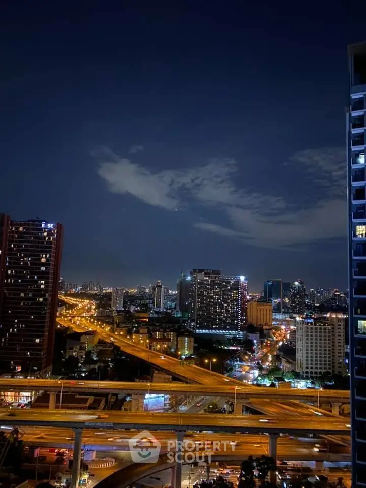 Stunning cityscape view from high-rise building at night with illuminated roads and skyline.