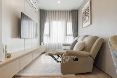Modern living room with sleek furniture and natural light, perfect for relaxation and entertainment.