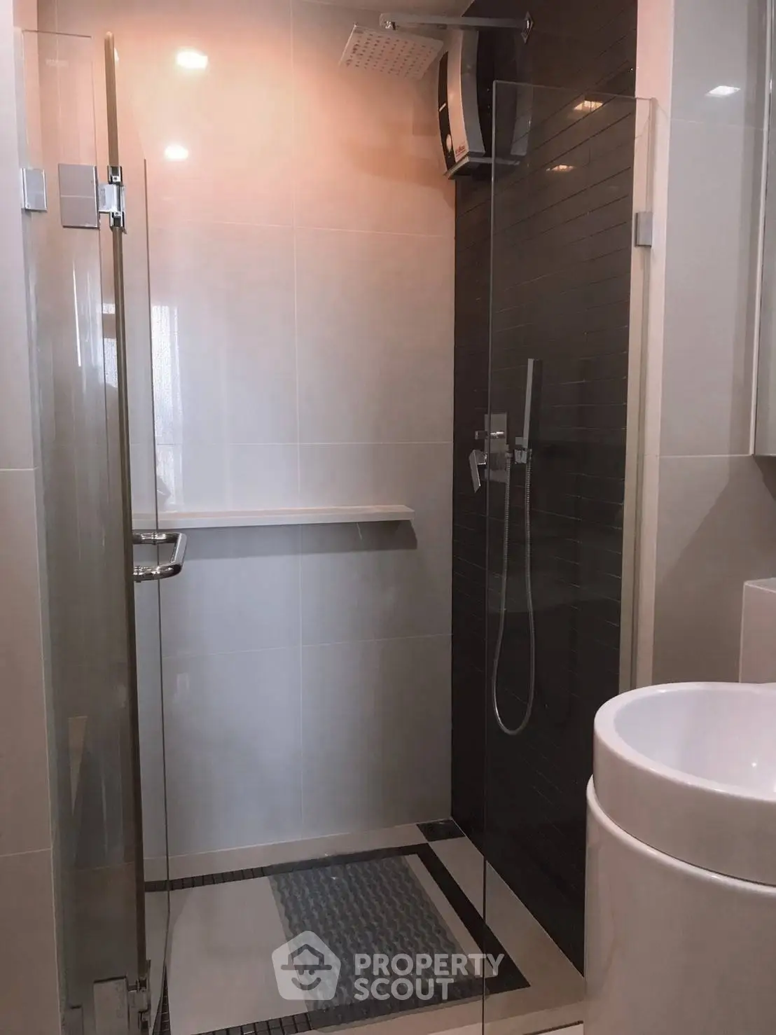 Modern bathroom with glass shower enclosure and sleek fixtures