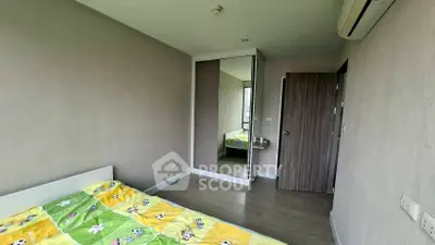 Cozy bedroom with mirrored wardrobe and air conditioning in modern apartment.