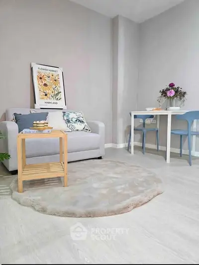 Charming living room with cozy sofa, stylish decor, and elegant dining area in modern apartment.