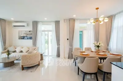Elegant living and dining area with modern decor and natural light
