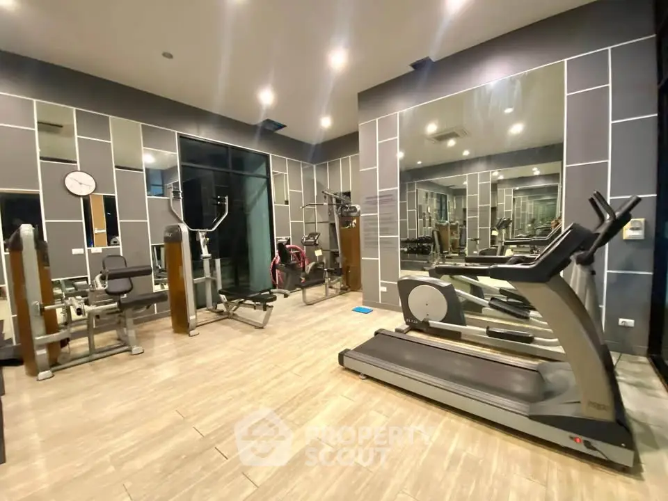 Modern gym with state-of-the-art fitness equipment and stylish interior design.