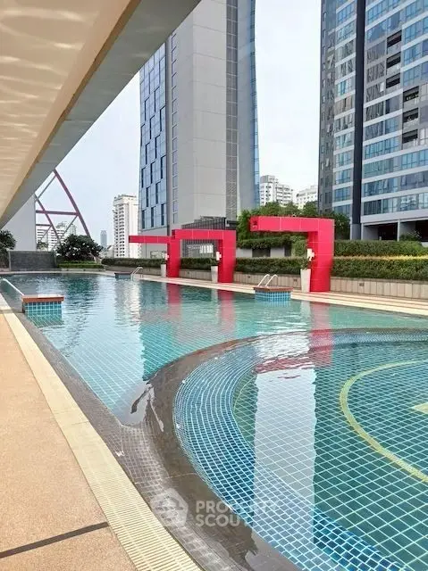 Luxurious rooftop pool with stunning city views in modern high-rise building.