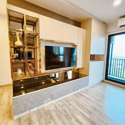 Modern living room with sleek TV unit and large window offering city view