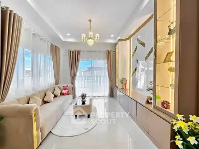 Elegant living room with plush sofa and modern decor, featuring large windows and abundant natural light.