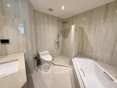 Luxurious modern bathroom with elegant tiling and spacious bathtub