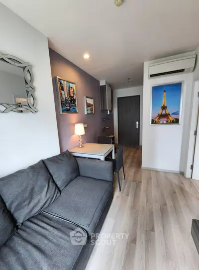 Modern living room with stylish decor and cozy seating in a contemporary apartment.