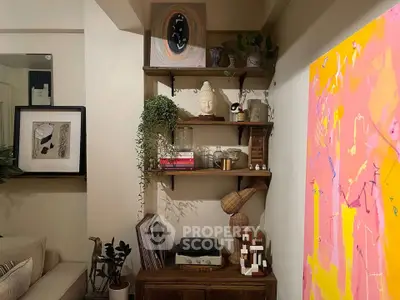 Stylish living room with modern art and elegant decor, featuring a cozy seating area and vibrant wall paintings.
