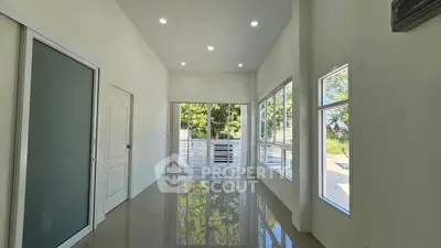 Spacious modern living room with large windows and glossy floors