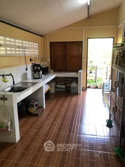 Spacious kitchen with open layout and natural light, featuring modern appliances and ample storage.
