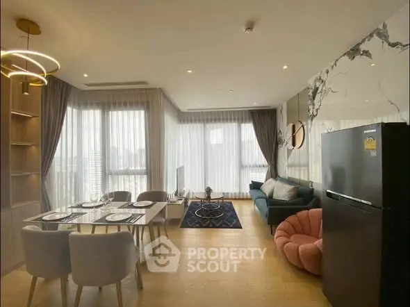 Modern open-plan living room with elegant decor and large windows