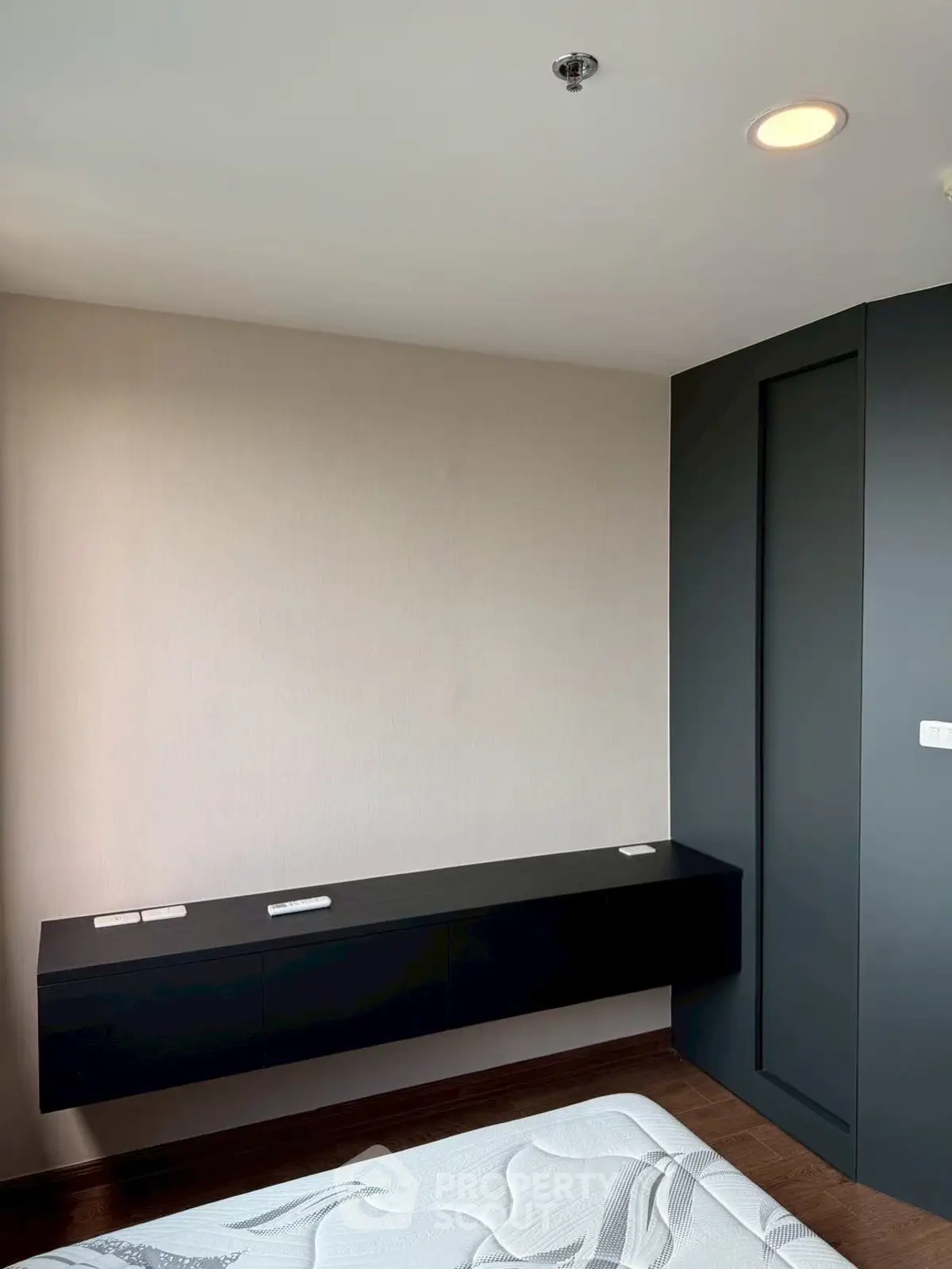 Modern bedroom with sleek black floating shelf and minimalist design