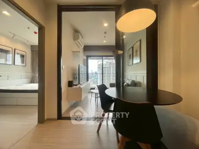 Modern apartment interior with open living and dining area, featuring city view and stylish decor.