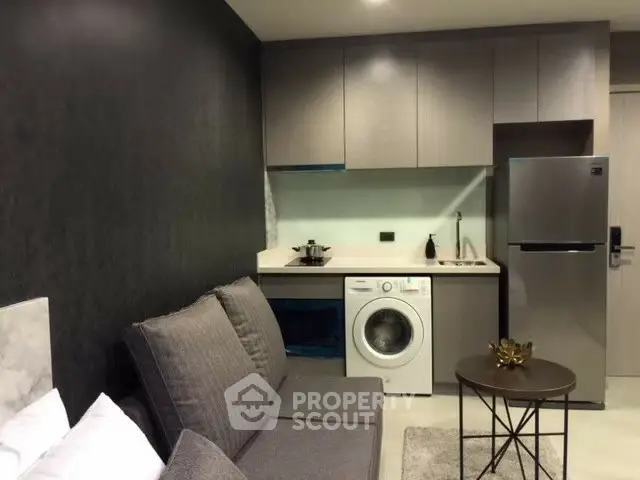 Modern studio apartment with compact kitchen and cozy living area