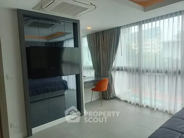 Modern bedroom with large windows and stylish decor