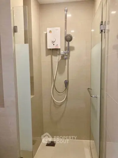 Modern bathroom with sleek shower design and neutral tiles