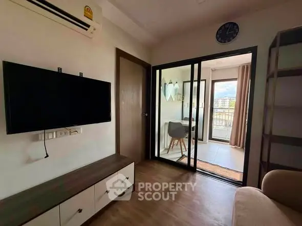 Modern living room with wall-mounted TV and balcony view in stylish apartment