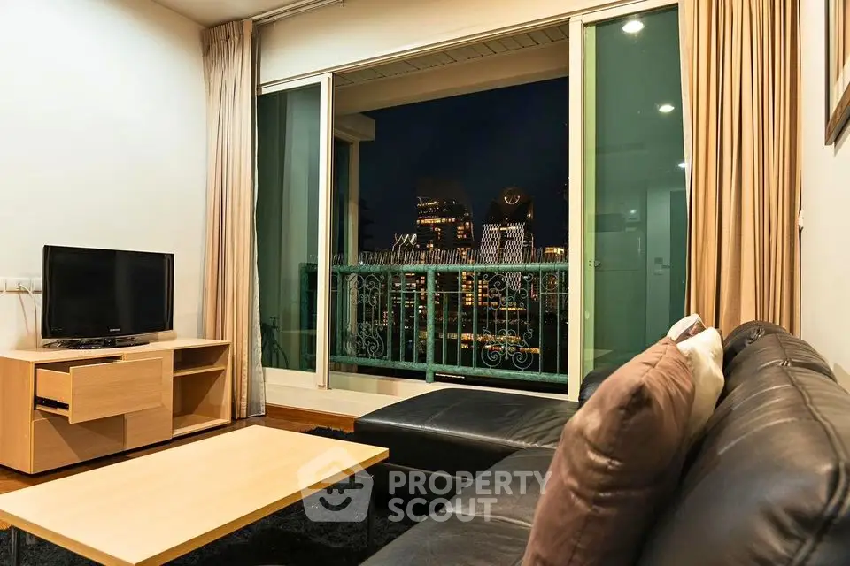 Modern living room with city view, featuring sleek furniture and large windows for natural light.