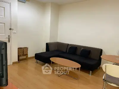 Cozy living room with modern sofa and coffee table, perfect for relaxation.