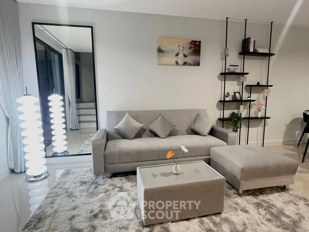 Modern living room with stylish gray sofa and elegant decor