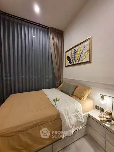 Cozy bedroom with modern decor and large window offering stunning night views.