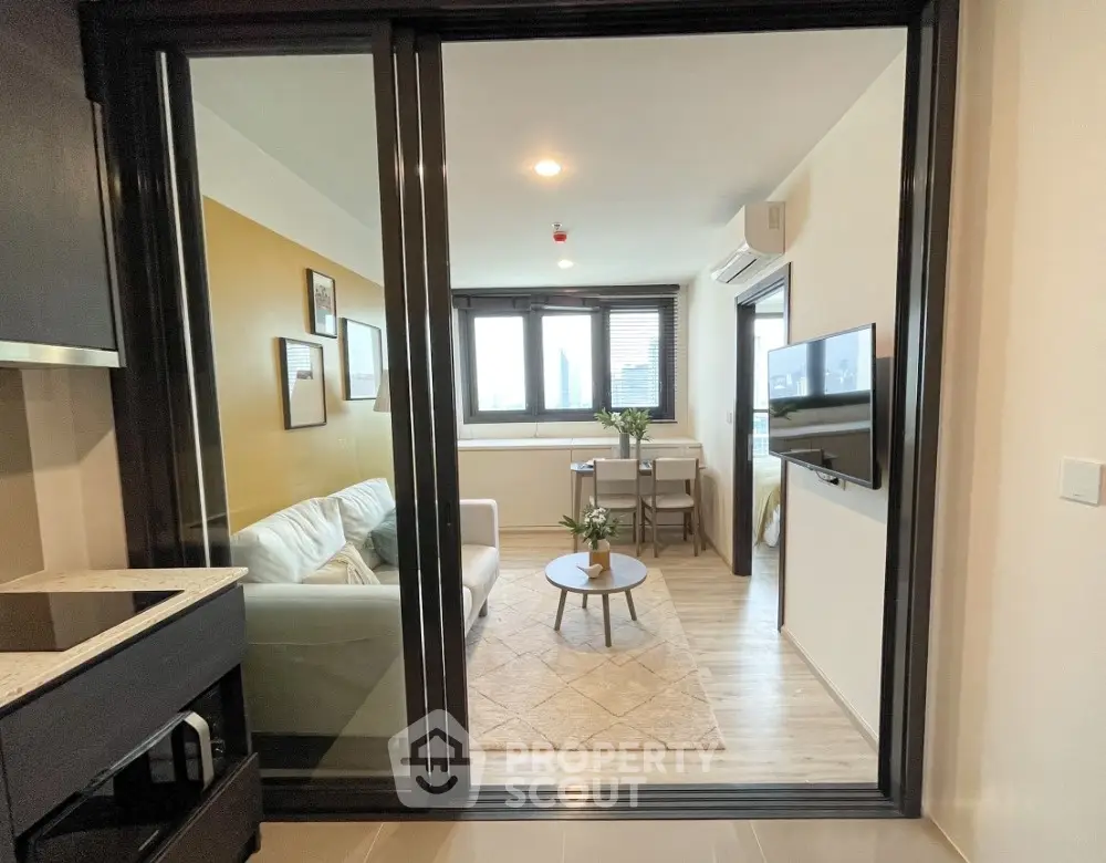Modern living room with cozy sofa and wall-mounted TV in stylish apartment