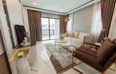 Luxurious modern living room with elegant decor and large windows offering natural light.