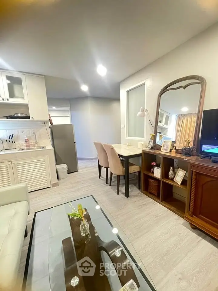 Modern living room with open kitchen, elegant dining area, and stylish decor in a cozy apartment.