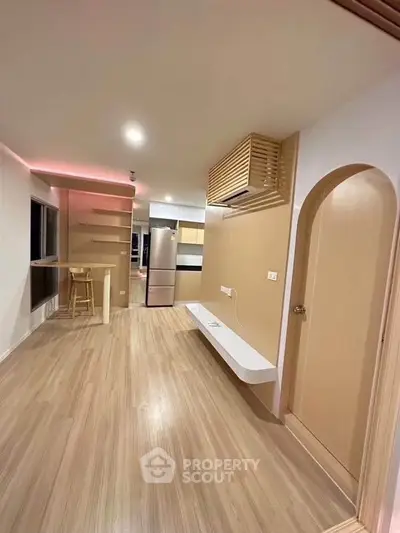 Modern open-plan living room with sleek kitchen and stylish lighting, perfect for contemporary living.