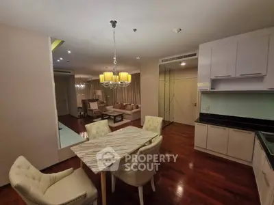 Elegant dining and living area with modern lighting and hardwood floors