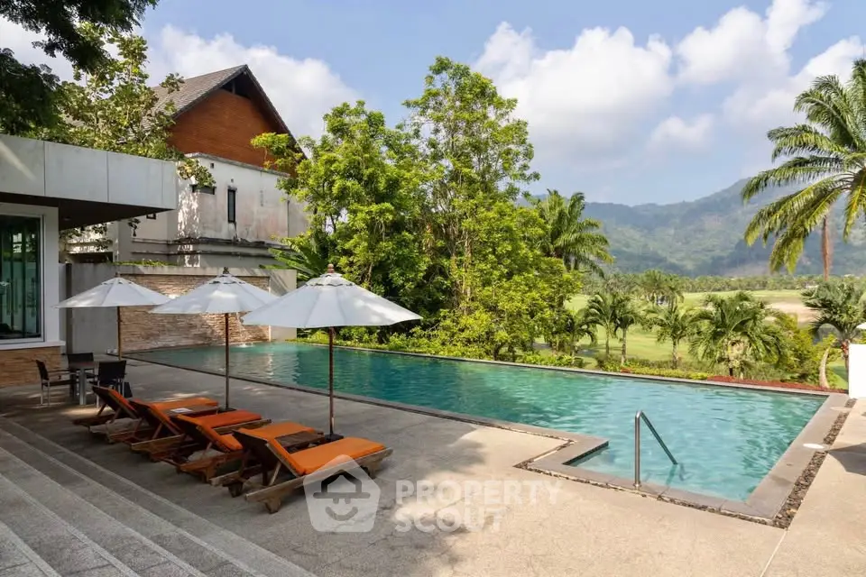 Luxurious poolside with scenic mountain views and lush greenery, perfect for relaxation and leisure.