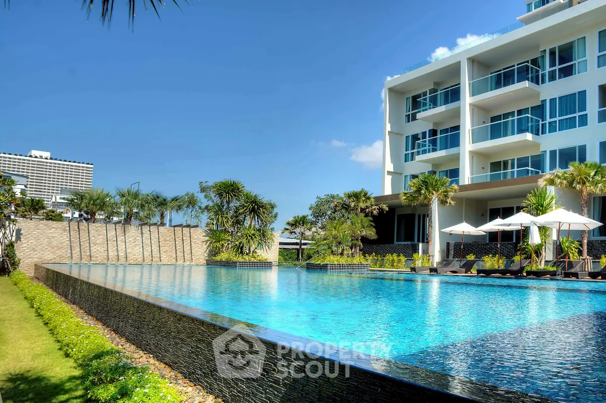 Luxurious modern apartment with stunning pool and lush garden view.