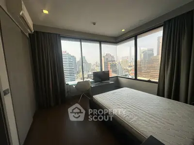 Modern bedroom with city view, large windows, and minimalist decor