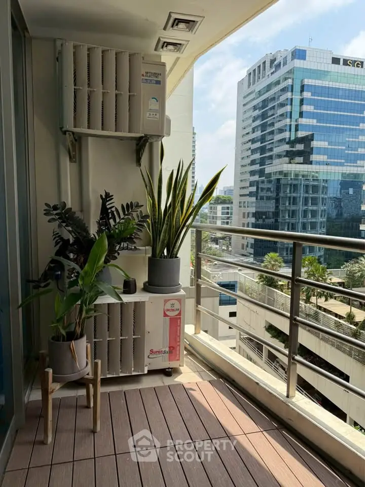 Modern balcony with city view, featuring potted plants and sleek railing design.