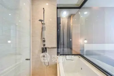 Luxurious bathroom with modern shower and bathtub in elegant apartment.