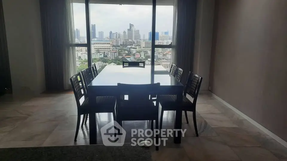 Spacious dining area with stunning city view through large windows, perfect for urban living.