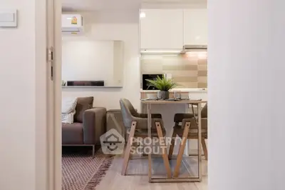 Modern open-plan living room and kitchen with stylish furniture and decor